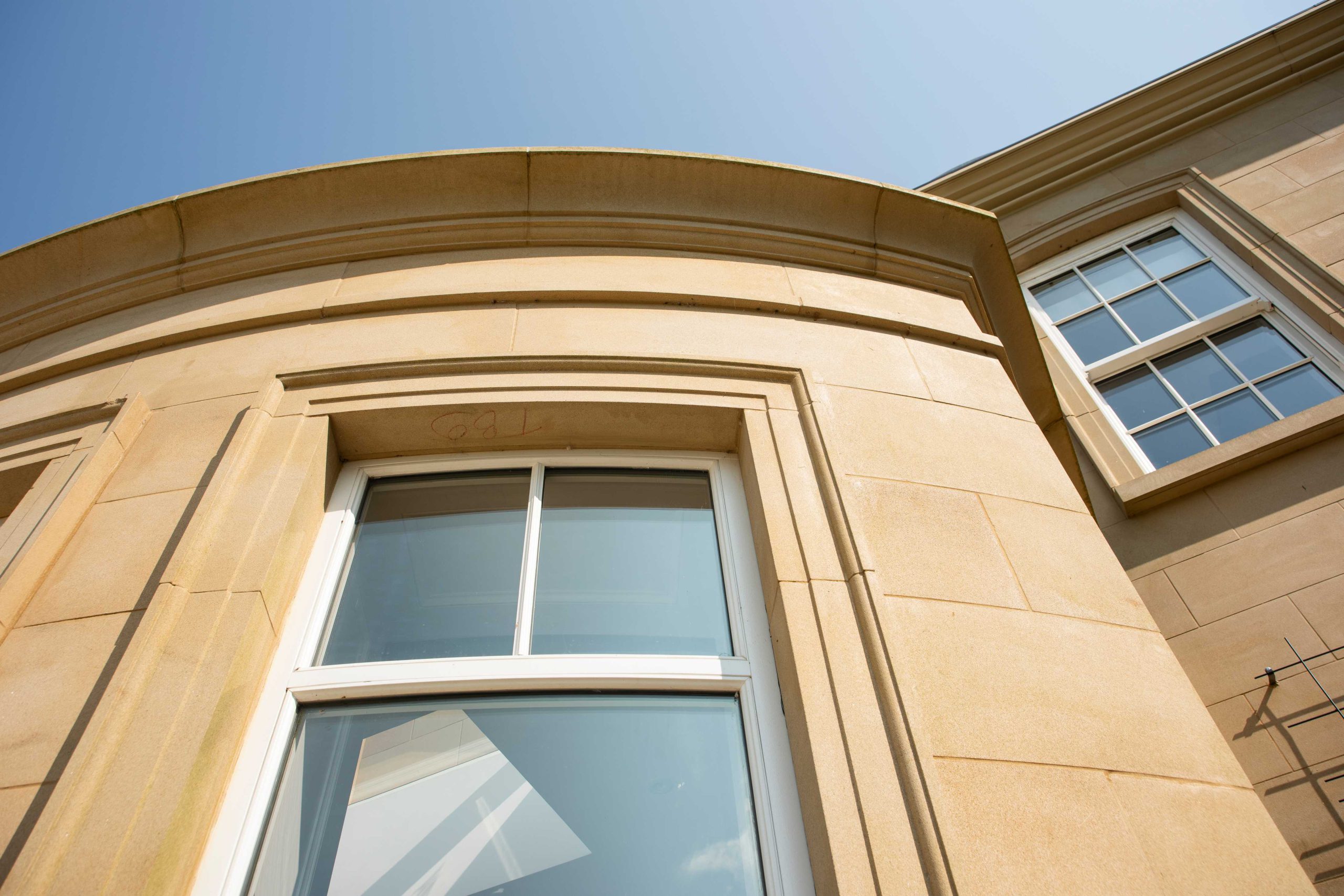 A picture of yellow building showing the finish on natural stone